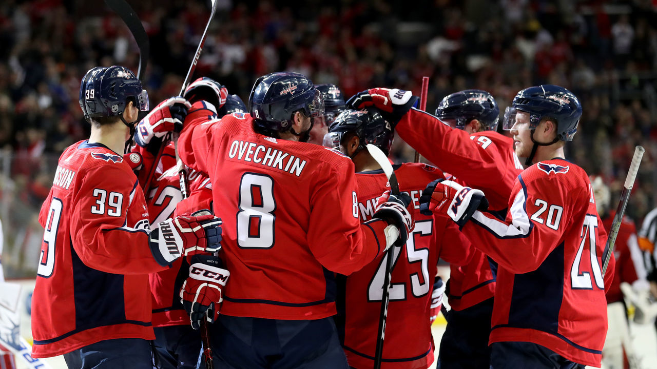 WASHINGTON, DC - MARCH 28: Members of the Washington Capitals celebrate after defeating the New York Rangers 3-2 in overtime at Capital One Arena on March 28, 2018 in Washington, DC.