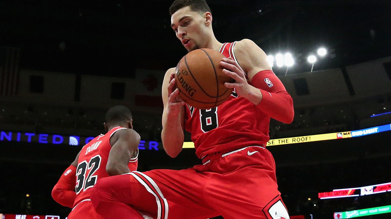 CHICAGO, IL - JANUARY 15: Zach LaVine #8 of the Chicago Bulls rebounds over teammate Kris Dunn #32 against the Miami Heat at the United Center on January 15, 2018 in Chicago, Illinois. The Bulls defeated the Heat 199-111.