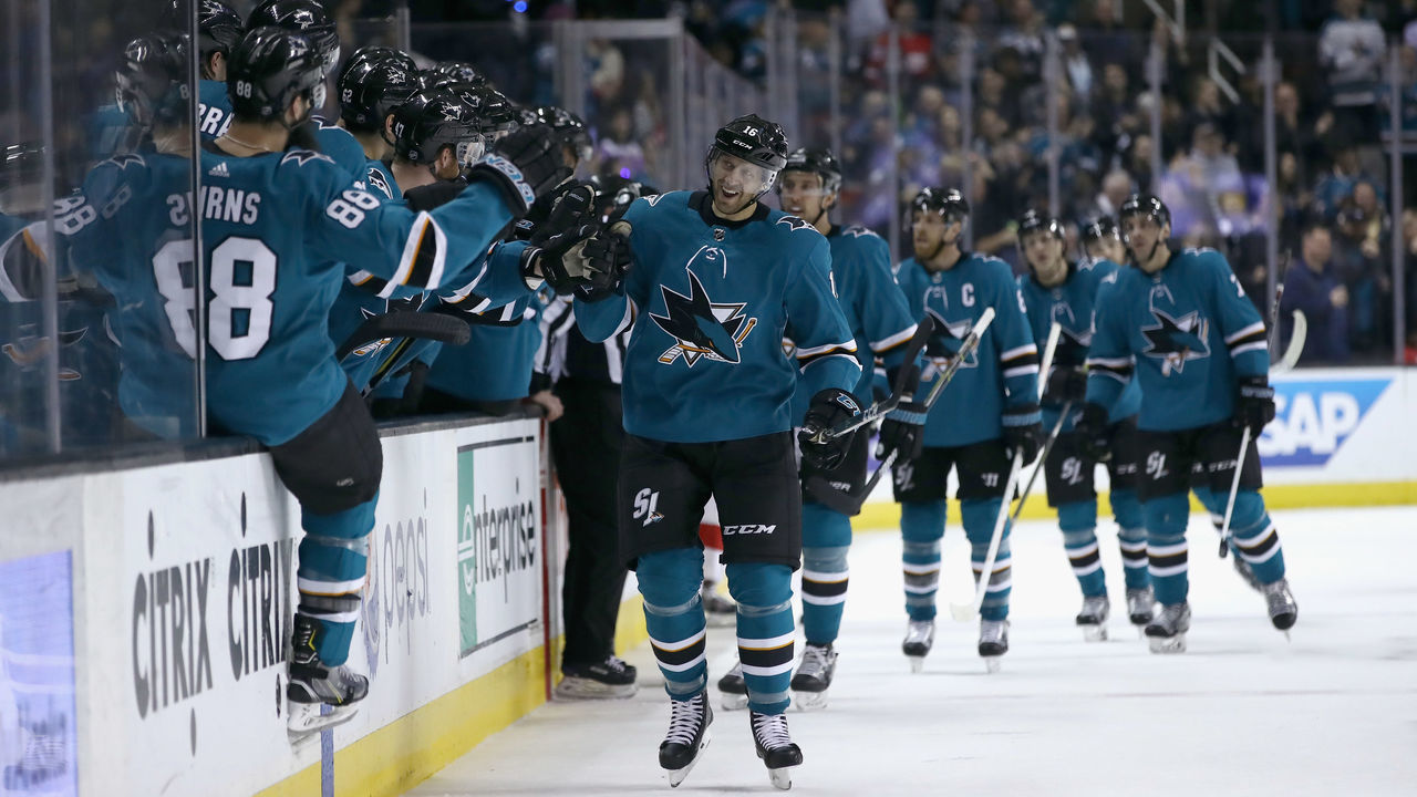 SAN JOSE, CA - MARCH 12: Eric Fehr #16 of the San Jose Sharks is congratulated by teammates on the bench after he scored his first goal as a San Jose Sharks against Jimmy Howard #35 of the Detroit Red Wings in the first period at SAP Center on March 12, 2018 in San Jose, California.