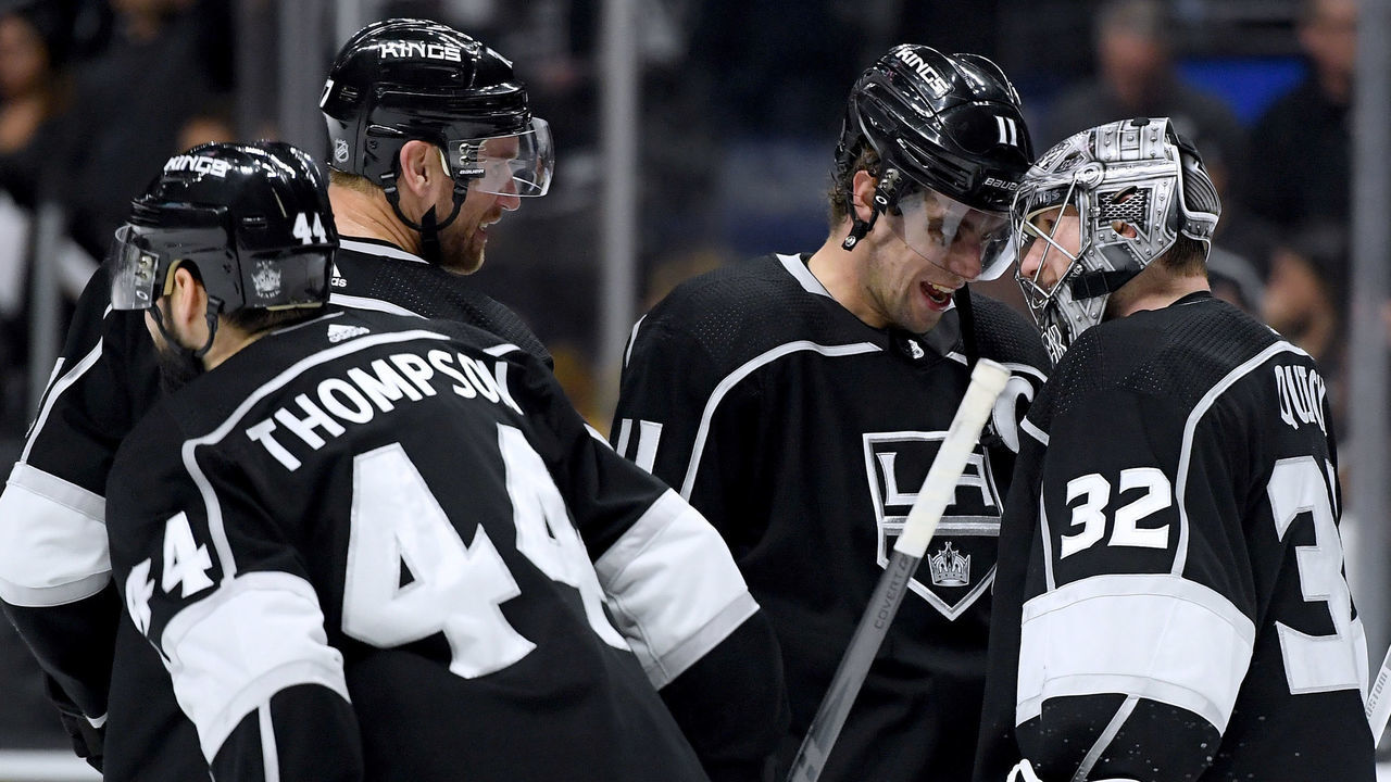 LOS ANGELES, CA - MARCH 26: Jonathan Quick #32 of the Los Angeles Kings celebrates a 3-0 win over the Calgary Flames with Anze Kopitar #11, Jeff Carter #77 and Nate Thompson #44 at Staples Center on March 26, 2018 in Los Angeles, California.