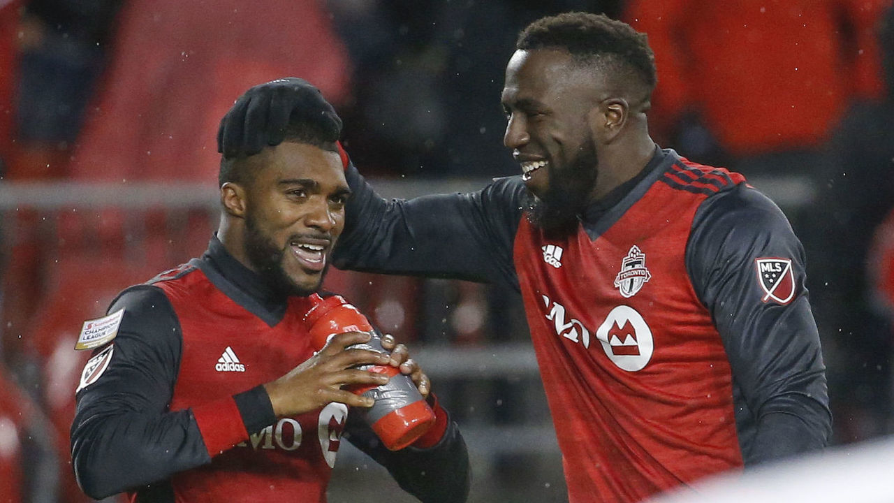TORONTO, ON - APRIL 3: Toronto FC defender Ashtone Morgan (5) grabs a quick drink and gets a head rub from Toronto FC forward Jozy Altidore (17) after netting the 3rd goal. Toronto FC vs Club America (Mexico) during 2nd half action in CONCACAF semi-final play at BMO Field. TFC won 3-1, taking the first leg of the semi-final. Toronto Star/Rick Madonik (Rick Madonik/Toronto Star via Getty Images)