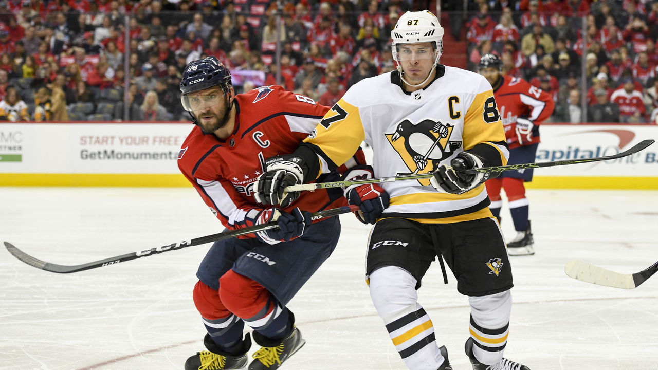 WASHINGTON, DC - NOVEMBER 10: Washington Capitals left wing Alex Ovechkin (8) and Pittsburgh Penguins center Sidney Crosby (87) fight for a second period puck on November 10, 2017, at the Capital One Arena in Washington, D.C.