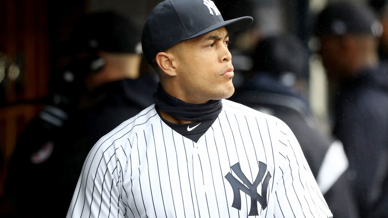 NEW YORK, NY - APRIL 03: Giancarlo Stanton #27 of the New York Yankees walks in the dugout before the game against the Tampa Bay Rays during Opening Day at Yankee Stadium on April 3, 2018 in the Bronx borough of New York City.