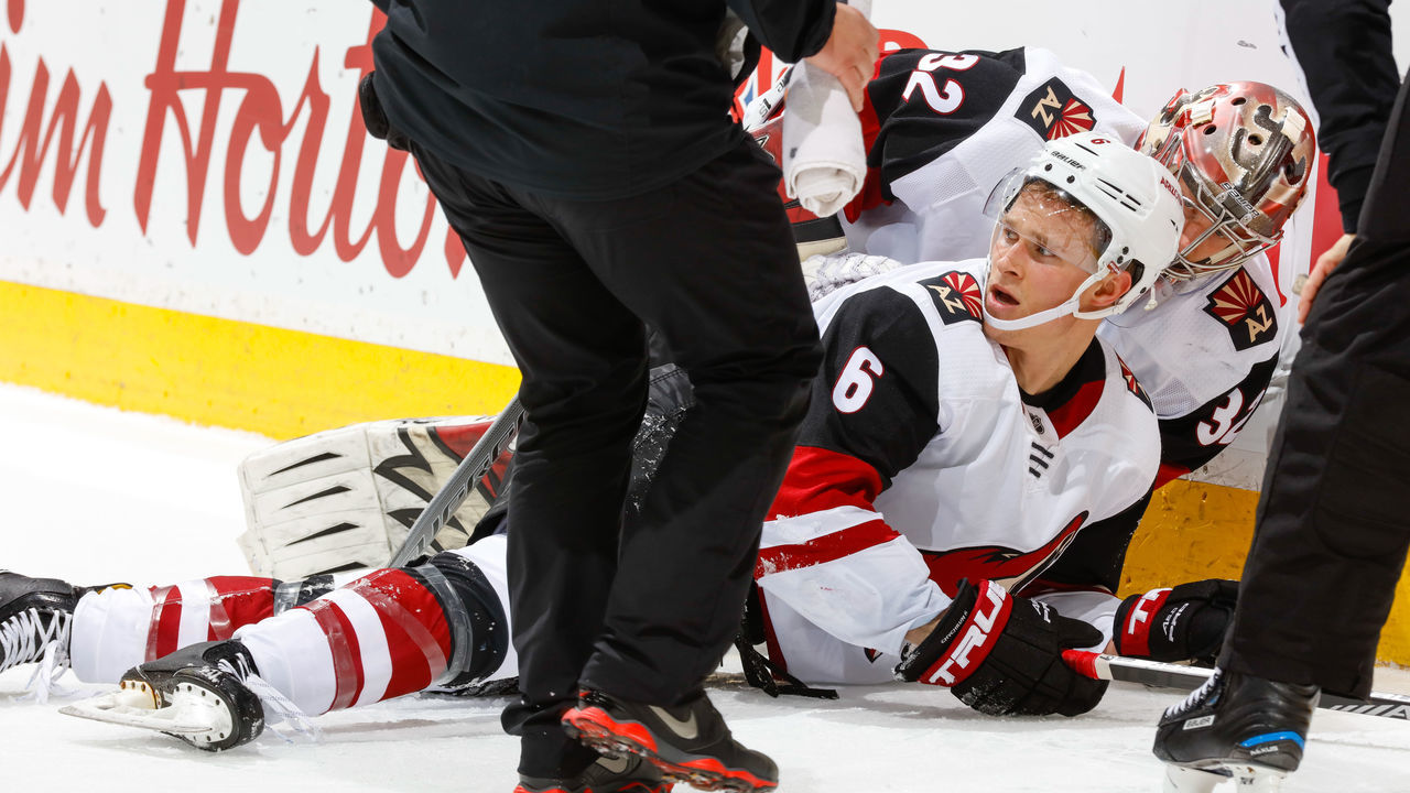 CALGARY, AB - APRIL 3: Antti Raanta #32 checks on teammate Jakob Chychrun #6 of the Arizona Coyotes in an NHL game on April 3, 2018 at the Scotiabank Saddledome in Calgary, Alberta, Canada.