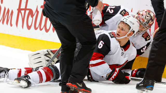 CALGARY, AB - APRIL 3: Antti Raanta #32 checks on teammate Jakob Chychrun #6 of the Arizona Coyotes in an NHL game on April 3, 2018 at the Scotiabank Saddledome in Calgary, Alberta, Canada.