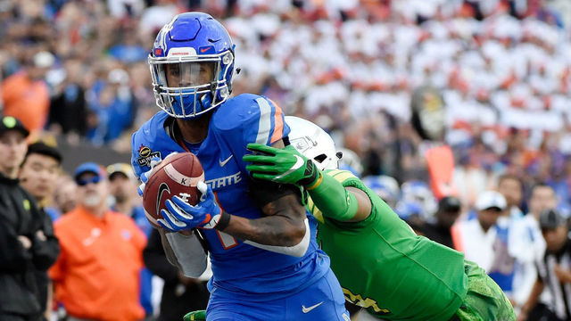LAS VEGAS, NV - DECEMBER 16: Cedrick Wilson #1 of the Boise State Broncos carries the ball against Thomas Graham Jr. #4 of the Oregon Ducks during the Las Vegas Bowl at Sam Boyd Stadium on December 16, 2017 in Las Vegas, Nevada. Boise State won 38-28.