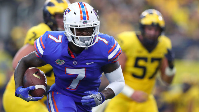 ARLINGTON, TX - SEPTEMBER 02: Duke Dawson #7 of the Florida Gators carries the ball on a touchdown run after an interception against the Michigan Wolverines in the second quarter of a game at AT&T Stadium on September 2, 2017 in Arlington, Texas.