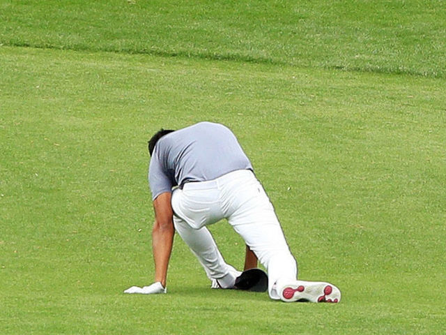 AUGUSTA, GA - APRIL 04: Tony Finau of the United States falls after rolling his ankle while celebrating his hole-in-one on the seventh hole during the Par 3 Contest prior to the start of the 2018 Masters Tournament at Augusta National Golf Club on April 4, 2018 in Augusta, Georgia.