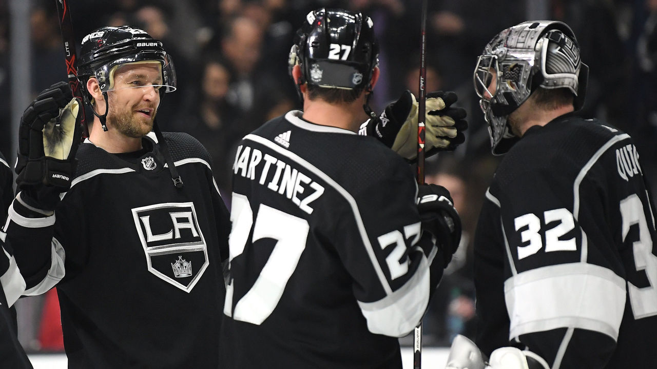 LOS ANGELES, CA - MARCH 08: Trevor Lewis #22 of the Los Angeles Kings celebrates a 3-1 win over the Washington Capitals with Jonathan Quick #32 and Alec Martinez #27 at Staples Center on March 8, 2018 in Los Angeles, California.