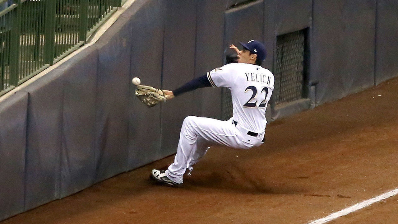 MILWAUKEE, WI - APRIL 04: Christian Yelich #22 of the Milwaukee Brewers slides to make a catch in the sixth inning against the St. Louis Cardinals at Miller Park on April 4, 2018 in Milwaukee, Wisconsin.