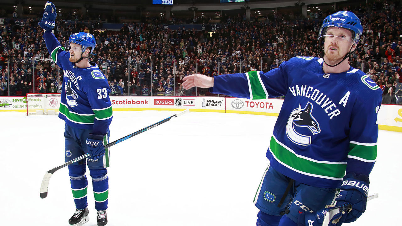 VANCOUVER, BC - April 3: Daniel Sedin #22 and Henrik Sedin #33 of the Vancouver Canucks skate up ice during their NHL game against the Vegas Golden Knights at Rogers Arena April 3, 2018 in Vancouver, British Columbia, Canada. 'n