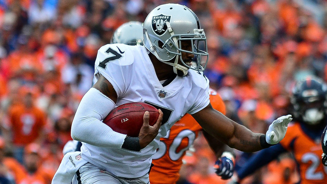 DENVER, CO - OCTOBER 1: Punter Marquette King #7 of the Oakland Raiders carries the ball on a fake punt play before being hit by tight end A.J. Derby #83 of the Denver Broncos at Sports Authority Field at Mile High on October 1, 2017 in Denver, Colorado.
