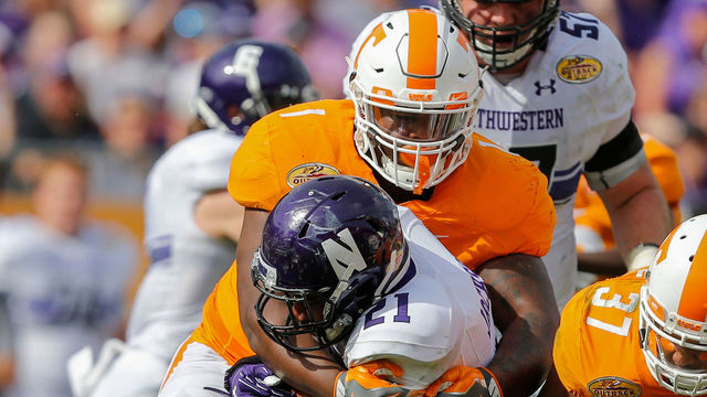 TAMPA, FL - JANUARY 1: Kahlil McKenzie #1 of the Tennessee Volunteers tackles Justin Jackson #21 of the Northwestern Wildcats during the Outback Bowl at Raymond James Stadium on January 1, 2016 in Tampa, Florida.