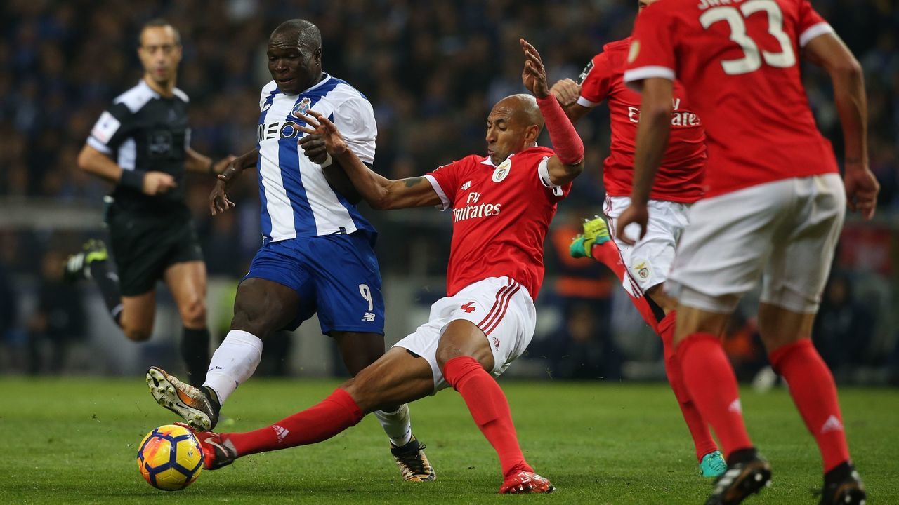 PORTO, PORTUGAL - DECEMBER 1: FC Porto forward Vincent Aboubakar from Cameroon tackled by SL Benfica defender Luisao from Brazil during the Primeira Liga match between FC Porto and SL Benfica at Estadio do Dragao on December 1, 2017 in Porto, Portugal.