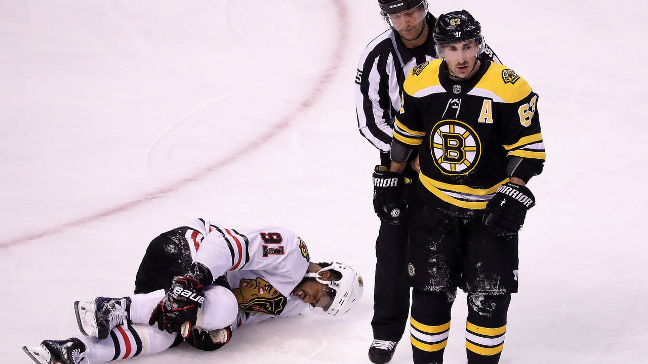 BOSTON - MARCH 10: Boston Bruins left wing Brad Marchand (63) heads to the penalty box after his open-ice hit on Chicago Blackhawks left wing Anthony Duclair (91) during the first period. The Boston Bruins host the Chicago Blackhawks in a regular season NHL hockey game at TD Garden in Boston on March 10, 2018.