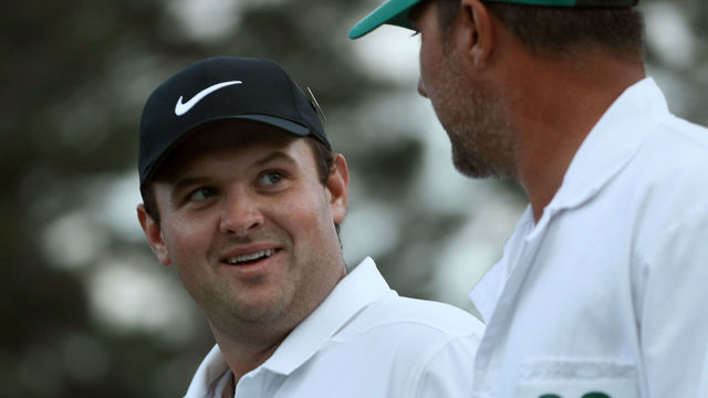 AUGUSTA, GA - APRIL 06: Patrick Reed of the United States talks with caddie Kessler Karain on the 18th green during the second round of the 2018 Masters Tournament at Augusta National Golf Club on April 6, 2018 in Augusta, Georgia.