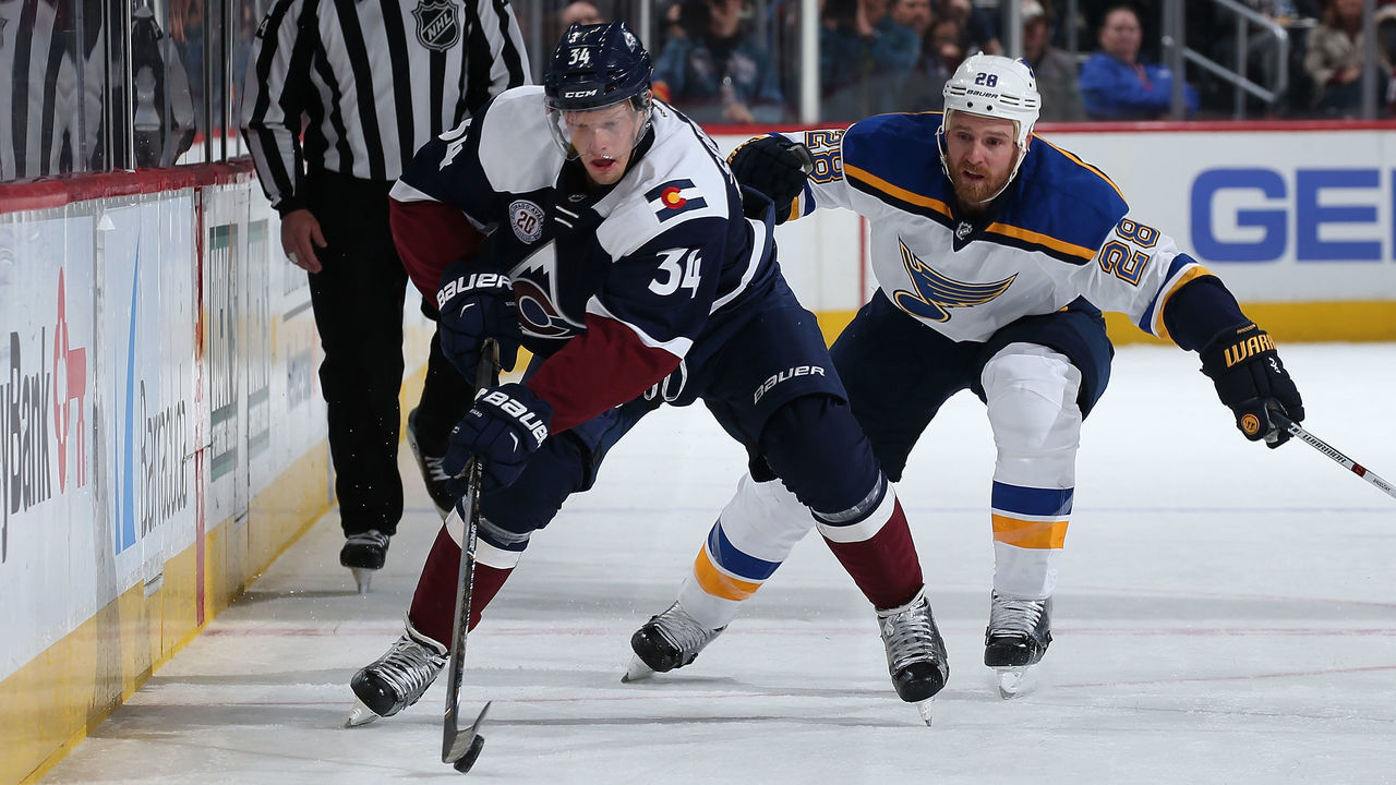 DENVER, CO - APRIL 03: Carl Soderberg #34 of the Colorado Avalanche controls the puck against Kyle Brodziak #28 of the St. Louis Blues at Pepsi Center on April 3, 2016 in Denver, Colorado. The Blues defeated the Avalanche 5-1.
