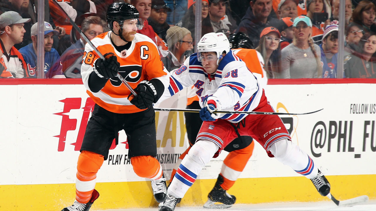 PHILADELPHIA, PA - APRIL 07: Claude Giroux #28 of the Philadelphia Flyers is checked by John Gilmour #58 of the New York Rangers during the first period at the Wells Fargo Center on April 7, 2018 in Philadelphia, Pennsylvania.