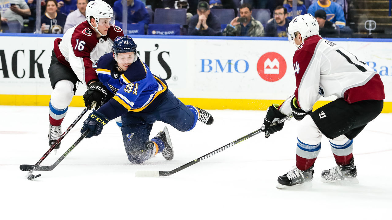 ST. LOUIS, MO - MARCH 15: St. Louis Blues' Vladimir Tarasenko, center, goes for a loose puck against Colorado Avalanche's Nikita Zadorov, left, and Blake Comeau, right, during the third period of an NHL hockey game. The Colorado Avalanche defeated the St. Louis Blues 4-1 on March 15, 2018, at Scottrade Center in St. Louis, MO.