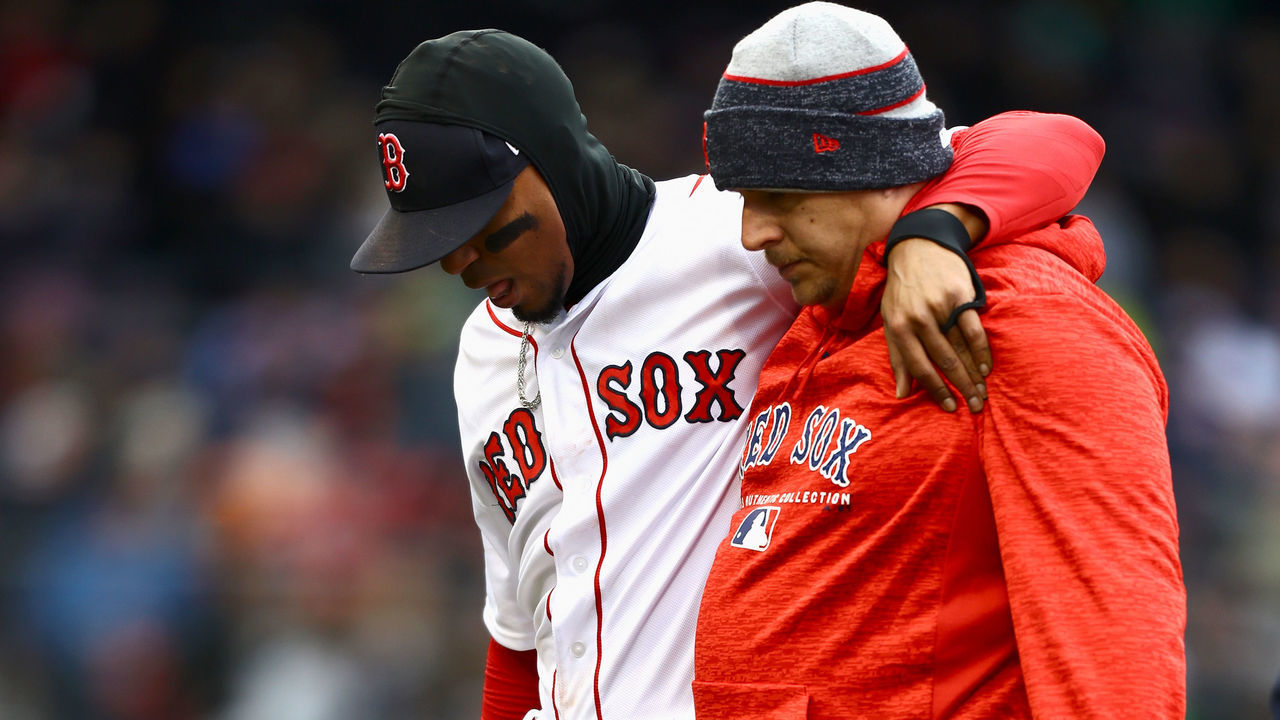BOSTON, MA - APRIL 08: Xander Bogaerts #2 of the Boston Red Sox is helped from the field after making a sliding play in the top of the seventh inning of the game against the Tampa Bay Rays at Fenway Park on April 8, 2018 in Boston, Massachusetts.