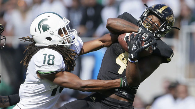 EAST LANSING, MI - SEPTEMBER 09: Cornerback Darius Phillips #4 of the Western Michigan Broncos intercepts a pass intended for wide receiver Felton Davis III #18 of the Michigan State Spartans during the first quarter at Spartan Stadium on September 9, 2017 in East Lansing, Michigan.