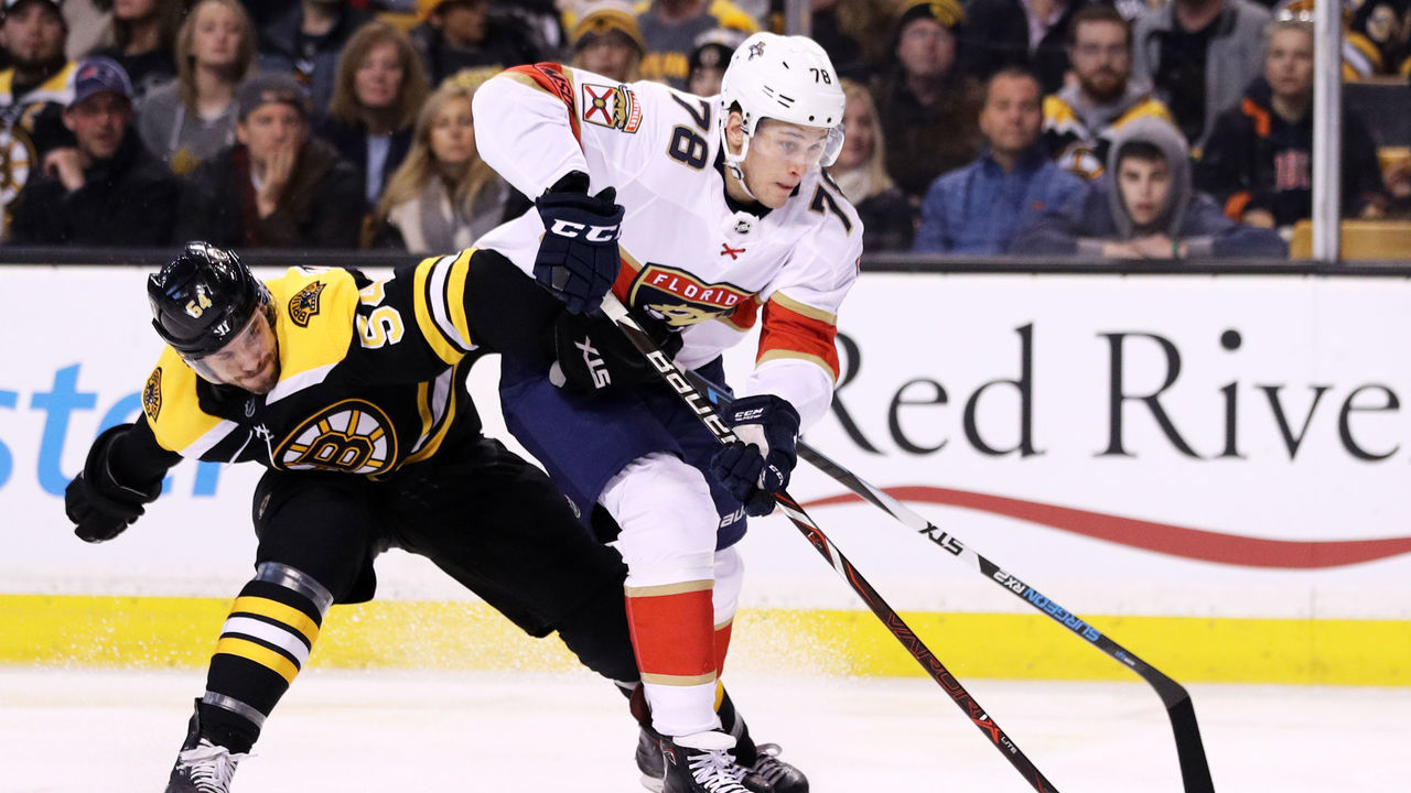 BOSTON, MA - APRIL 08: Maxim Mamin #78 of the Florida Panthers and Adam McQuaid #54 of the Boston Bruins battle for control of the puck during the second period at TD Garden on April 8, 2018 in Boston, Massachusetts.