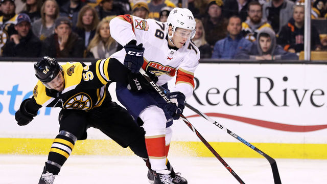 BOSTON, MA - APRIL 08: Maxim Mamin #78 of the Florida Panthers and Adam McQuaid #54 of the Boston Bruins battle for control of the puck during the second period at TD Garden on April 8, 2018 in Boston, Massachusetts.