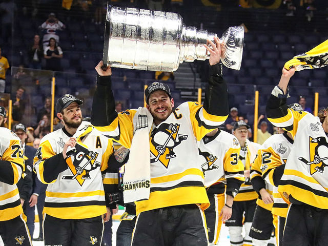 NASHVILLE, TN - JUNE 11: Sidney Crosby #87 of the Pittsburgh Penguins and his teammates celebrate with the Stanley Cup trophy after defeating the Nashville Predators 2-0 in Game Six of the 2017 NHL Stanley Cup Final at the Bridgestone Arena on June 11, 2017 in Nashville, Tennessee.