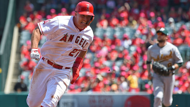 ANAHEIM, CA - APRIL 08: Mike Trout #27 of the Los Angeles Angels rounds third on his way to score a run on a double by Albert Pujols #5 of the Los Angeles Angels in the first inning of the game against the Oakland Athletics at Angel Stadium of Anaheim on April 8, 2018 in Anaheim, California.