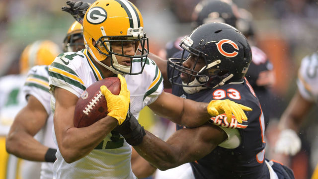 CHICAGO, IL - NOVEMBER 12: Trevor Davis #11 of the Green Bay Packers carries the football against Sam Acho #93 of the Chicago Bears in the second quarter at Soldier Field on November 12, 2017 in Chicago, Illinois.