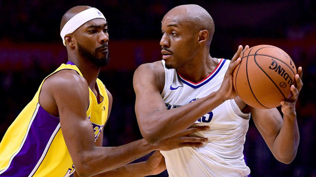LOS ANGELES, CA - OCTOBER 13: C.J. Williams #9 of the LA Clippers hangs on to the ball in front of Corey Brewer #3 of the Los Angeles Lakers during a 111-104 Laker win at Staples Center on October 10, 2017 in Los Angeles, California.
