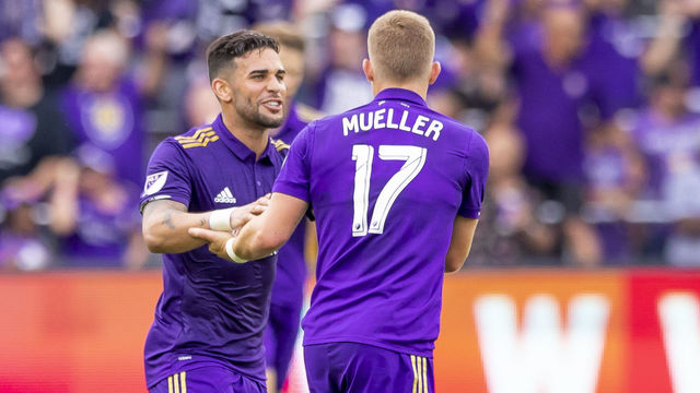 ORLANDO, FL - APRIL 08: Orlando City forward Dom Dwyer (14) celebrates with Orlando City forward Chris Mueller (17) giving orlando its first goal during the MLS soccer match between the Orlando City FC and the Portland Timbers at Orlando City SC on April 8, 2018 at Orlando City Stadium in Orlando, FL.