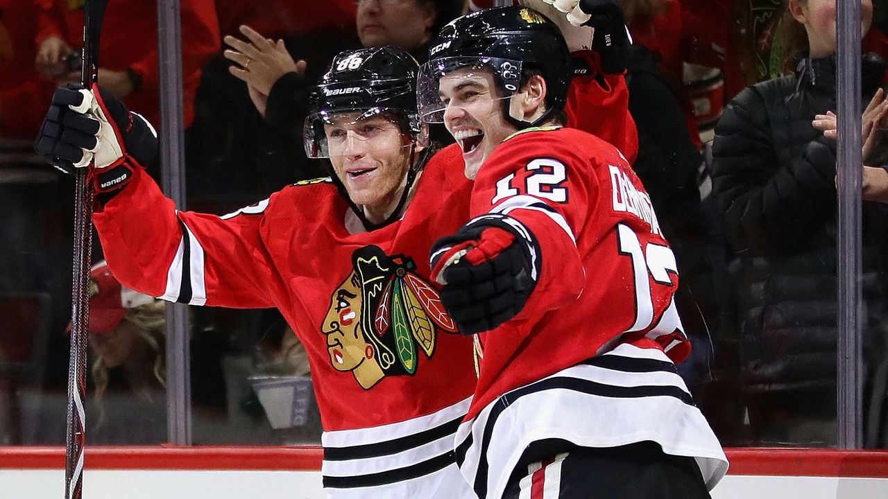 CHICAGO, IL - NOVEMBER 27: Patrick Kane #88 (L) and Alex DeBrincat #12 of the Chicago Blackhawks celebrate DeBrincat's thrid goal of the game in the second period against the Anaheim Ducks at the United Center on November 27, 2017 in Chicago, Illinois.