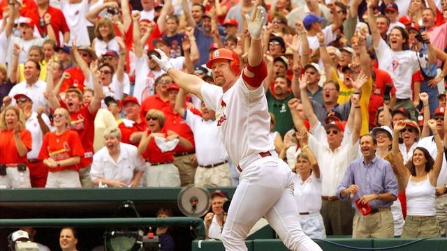ST. LOUIS, UNITED STATES: Mark McGwire of the St. Louis Cardinals celebrates after hitting his 61st homerun against Chicago Cub's Mike Morgan at Busch Stadium 07 September in St. Louis, MO. McGwire tied the record set by Roger Maris in 1961. (ELECTRONIC IMAGE) AFP PHOTO/Jeff HAYNES