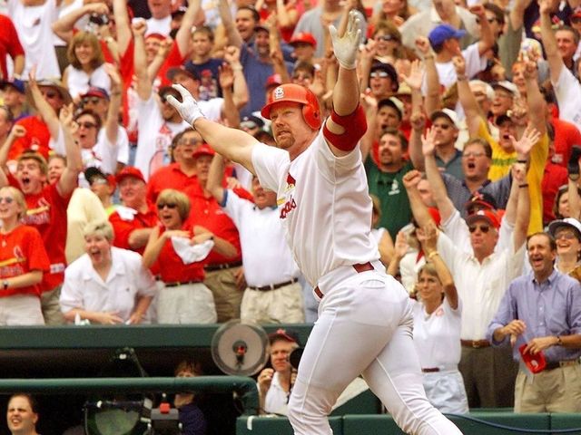 ST. LOUIS, UNITED STATES: Mark McGwire of the St. Louis Cardinals celebrates after hitting his 61st homerun against Chicago Cub's Mike Morgan at Busch Stadium 07 September in St. Louis, MO. McGwire tied the record set by Roger Maris in 1961. (ELECTRONIC IMAGE) AFP PHOTO/Jeff HAYNES