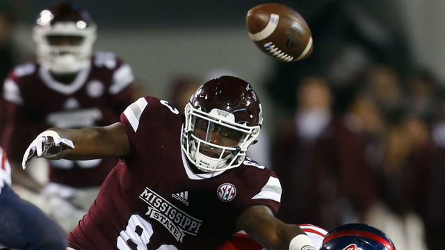 STARKVILLE, MS - NOVEMBER 23: Jordan Thomas #83 of the Mississippi State Bulldogs fumbles the ball as he is tackled by Tayler Polk #24 and Javien Hamilton #21 of the Mississippi Rebels during the second half of an NCAA football game at Davis Wade Stadium on November 23, 2017 in Starkville, Mississippi.