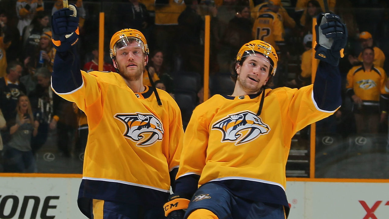 NASHVILLE, TN - MARCH 27: Mattias Ekholm #14 and Filip Forsberg #9 of the Nashville Predators celebrate after a 2-1 shootout win over the Minnesota Wild at Bridgestone Arena on March 27, 2018 in Nashville, Tennessee.