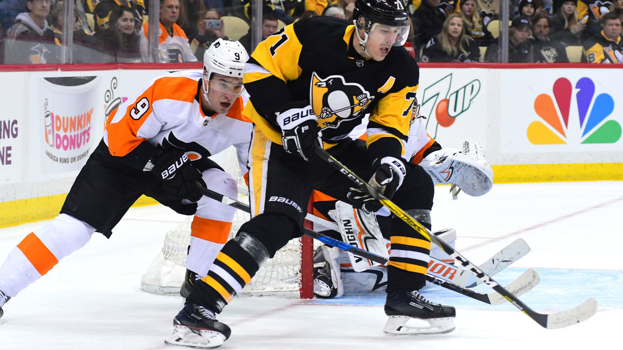 PITTSBURGH, PA - MARCH 25: Evgeni Malkin #71 of the Pittsburgh Penguins skates with the puck against Ivan Provorov #9 of the Philadelphia Flyers at PPG PAINTS Arena on March 25, 2018 in Pittsburgh, Pennsylvania.