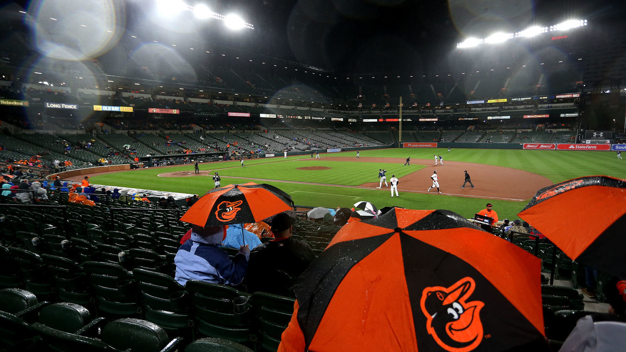 BALTIMORE, MD - APRIL 24: Fans watch action as rain falls in the fourth inning during a game between the Tampa Bay Rays and the Baltimore Orioles at Oriole Park at Camden Yards on April 24, 2017 in Baltimore, Maryland.