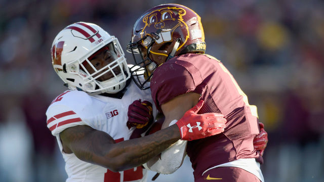 MINNEAPOLIS, MN - NOVEMBER 25: Natrell Jamerson #12 of the Wisconsin Badgers tackles Rodney Smith #1 of the Minnesota Golden Gophers during the first quarter of the game on November 25, 2017 at TCF Bank Stadium in Minneapolis, Minnesota.