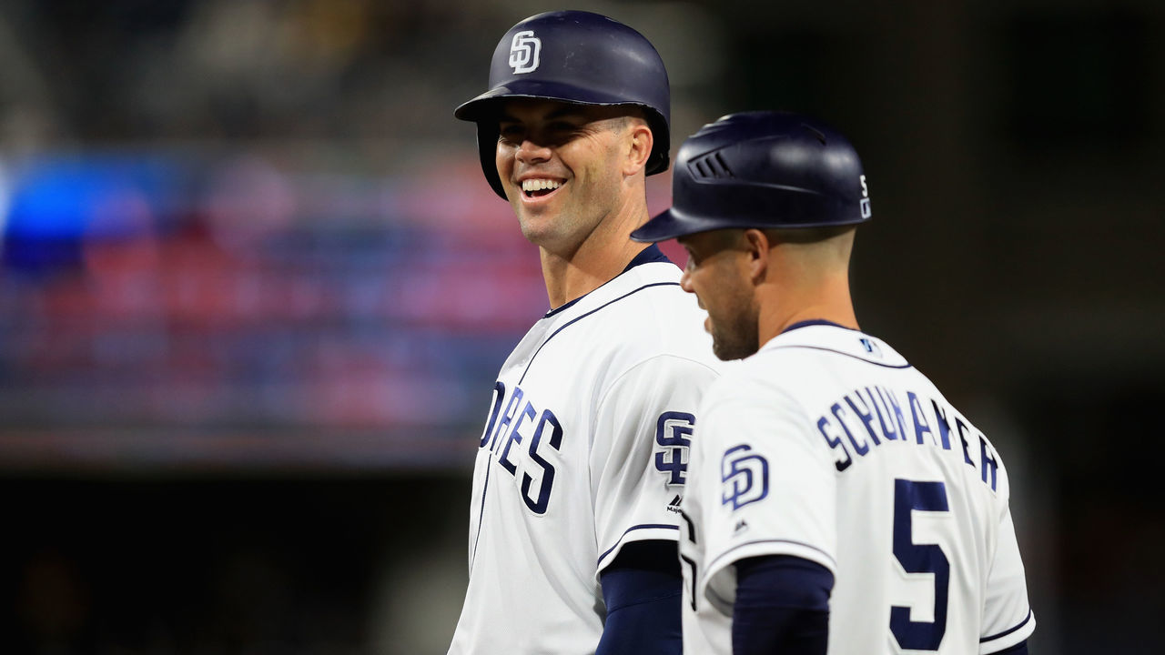 SAN DIEGO, CA - APRIL 12: Clayton Richard #3 shares a laugh with Skip Schumaker #5 of the San Diego Padres after hitting a single during the third inning of a game against the San Francisco Giants at PETCO Park on April 12, 2018 in San Diego, California.