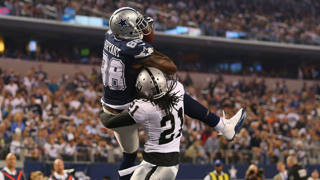 ARLINGTON, TX - NOVEMBER 28: Dez Bryant #88 of the Dallas Cowboys makes a touchdown pass reception against Mike Jenkins #21 of the Oakland Raiders at AT&T Stadium on November 28, 2013 in Arlington, Texas.