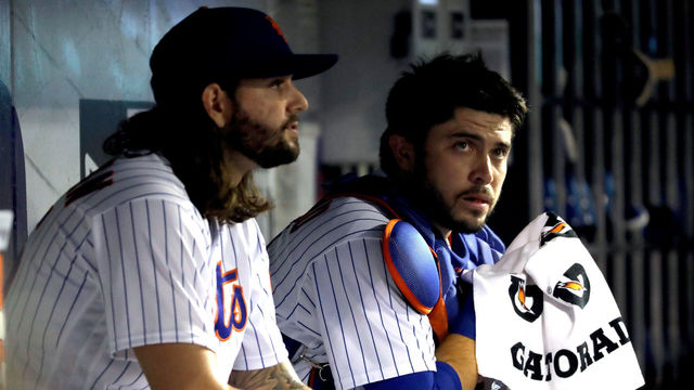NEW YORK, NY - SEPTEMBER 22: Robert Gsellman #65 (L) of the New York Mets talks with Travis d'Arnaud #18 during the first inning against the Washington Nationals on September 22, 2017 at Citi Field in the Flushing neighborhood of the Queens borough of New York City.