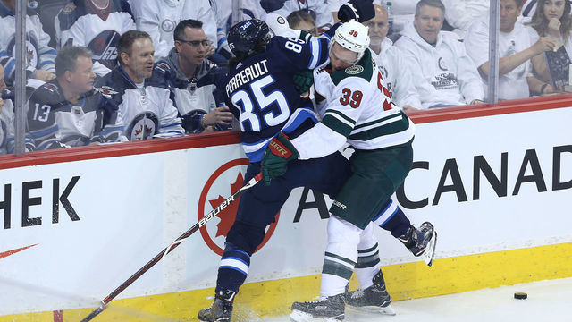 WINNIPEG, MANITOBA - APRIL 11: Mathieu Perreault #85 of the Winnipeg Jets battles Nate Prosser #29 of the Minnesota Wild in Game One of the Western Conference First Round during the 2018 NHL Stanley Cup Playoffs on April 11, 2018 at Bell MTS Place in Winnipeg, Manitoba, Canada.