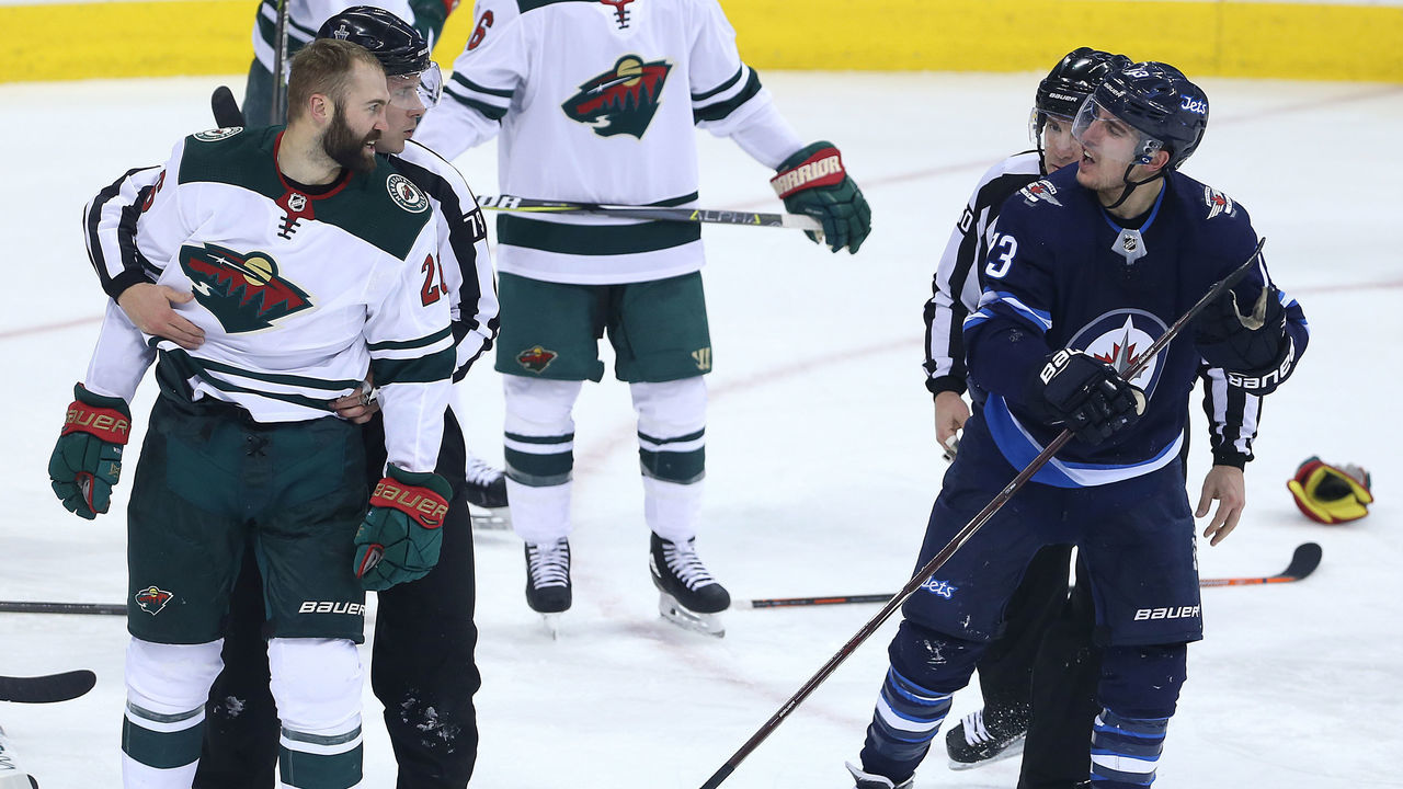 WINNIPEG, MANITOBA - APRIL 11: Brandon Tanev #13 of the Winnipeg Jets has words with Daniel Winnik #26 of the Minnesota Wild in Game One of the Western Conference First Round during the 2018 NHL Stanley Cup Playoffs on April 11, 2018 at Bell MTS Place in Winnipeg, Manitoba, Canada. *** Local Caption *** Brandon Tanev; Daniel Winnik