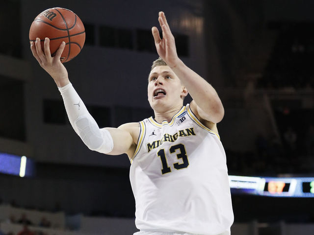 WICHITA, KS - MARCH 17: Moe Wagner #13 of the Michigan Wolverines lays up a shot against the Houston Cougars in the second round of the 2018 NCAA Men's Basketball Tournament held at INTRUST Arena on March 17, 2018 in Wichita, Kansas.