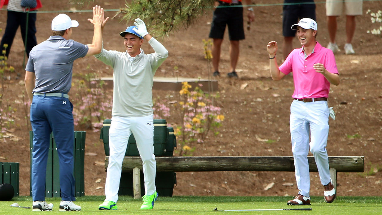 AUGUSTA, GEORGIA - APRIL 06: Rickie Fowler of the United States celebrates with Justin Thomas of the United States and Jordan Spieth of the United States after hitting a hole in one on the fourth hole during the Par 3 Contest prior to the start of the 2016 Masters Tournament at Augusta National Golf Club on April 6, 2016 in Augusta, Georgia.