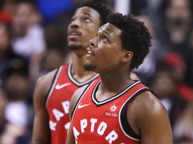TORONTO, ON - March 25 In second half action, both Toronto Raptors guard Kyle Lowry (7) and DeMar DeRozan look up to the scoreboard to watch a replay of a foul. The Toronto Raptors lost to the LA Clippers 117-106 in NBA basketball action at the Air Canada Centre (ACC) in Toronto. {man} 25, 2018 (Richard Lautens/Toronto Star via Getty Images)