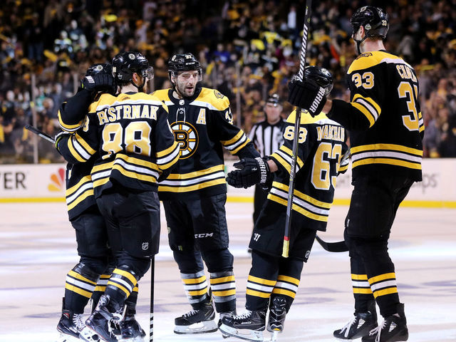 BOSTON, MA - APRIL 14: David Pastrnak #88 of the Boston Bruins, right, celebrates with Patrice Bergeron #37, Brad Marchand #63 and Zdeno Chara #33 after scoring a goal against the Toronto Maple Leafs during the third period of Game Two of the Eastern Conference First Round during the 2018 NHL Stanley Cup Playoffs at TD Garden on April 14, 2018 in Boston, Massachusetts. The Bruins defeat the Leafs 7-3.