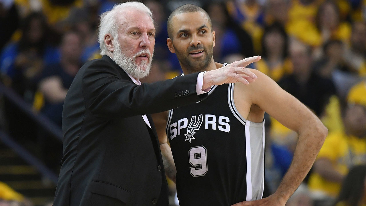 OAKLAND, CA - APRIL 14: Head coach Gregg Popovich of the San Antonio Spurs talks with his player Tony Parker #9 against the Golden State Warriors in the second quarter during Game One of the first round of the 2018 NBA Playoff at ORACLE Arena on April 14, 2018 in Oakland, California.